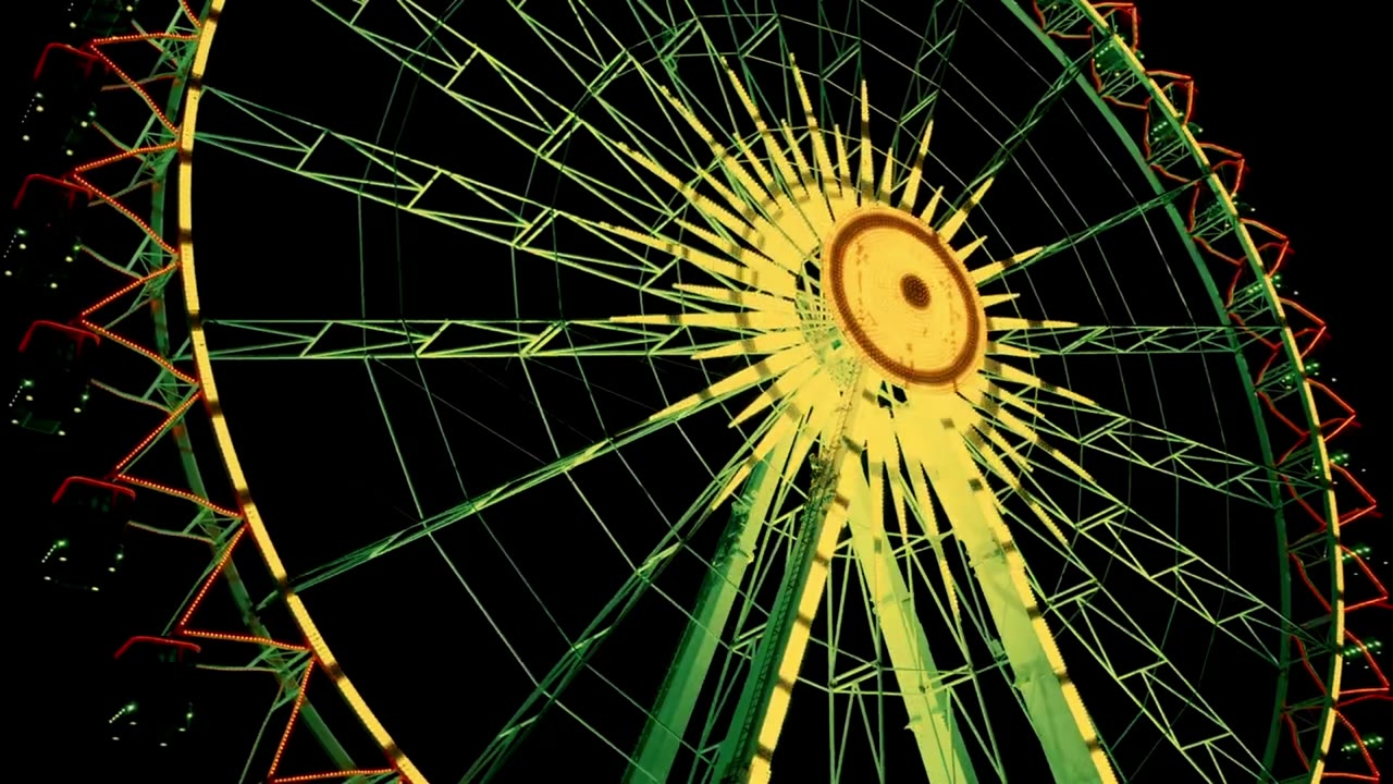 Garden of Light Stuttgart: ein beleuchtetes Riesenrad, das nachts grün und gelb leuchtet